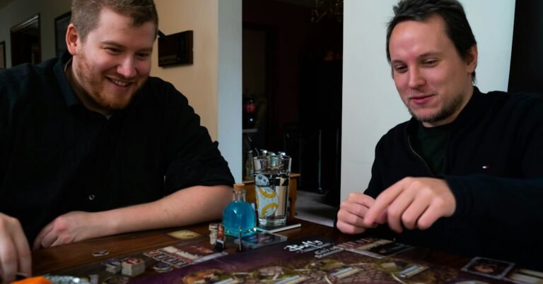 Two friends smiling while playing a board game