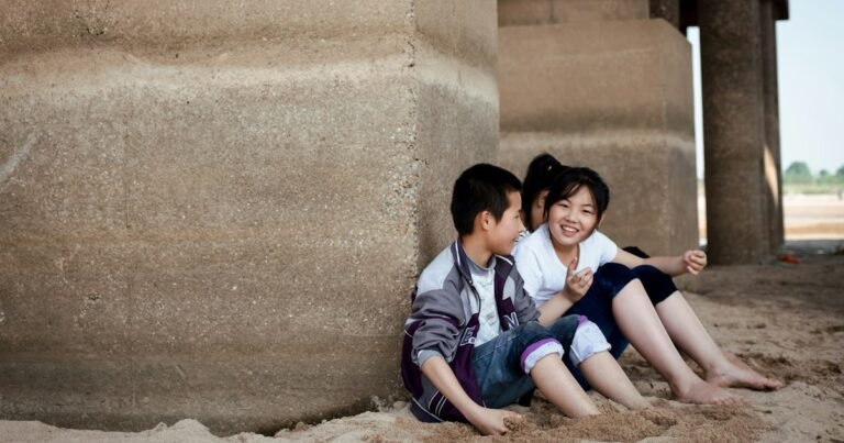 Two children sitting together and smiling shyly