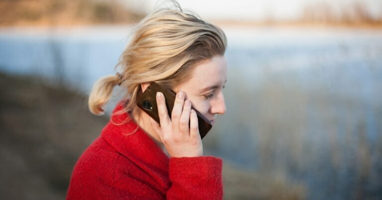 Young woman taking a phone call outdoors