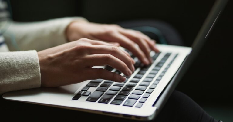 Hands typing a conversation on a laptop