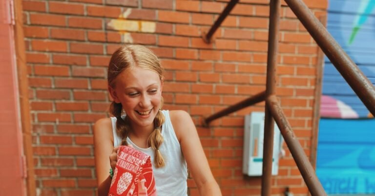 Smiling teenage girl holding a book, relaxed and confident
