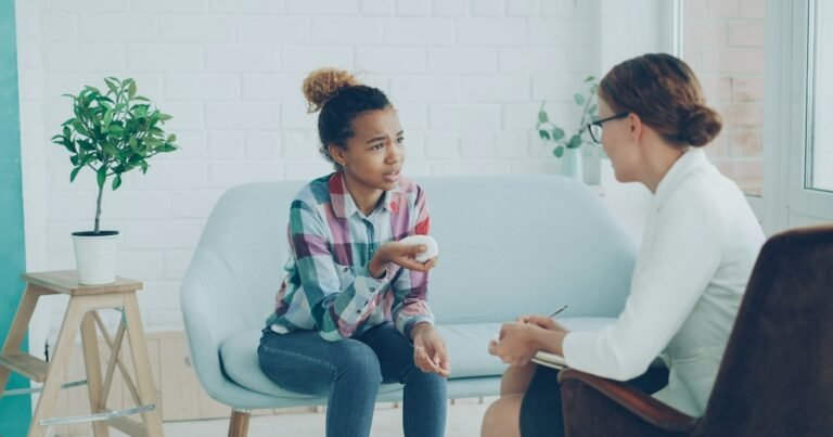 Young woman talking with a therapist in a bright room